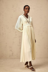 A white pleated midi dress with crystal trim details along the neckline and waist named Yana