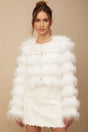 A white puffy fur jacket adorned with crystal embellishments in a floral pattern resembling a margherita design
