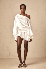 A white satin mini dress with deconstructed design elements named Xenia