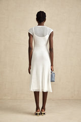 A white semisheer midi dress with scalloped hem and delicate details named Liane