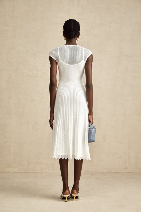 A white semisheer midi dress with scalloped hem and delicate details named Liane