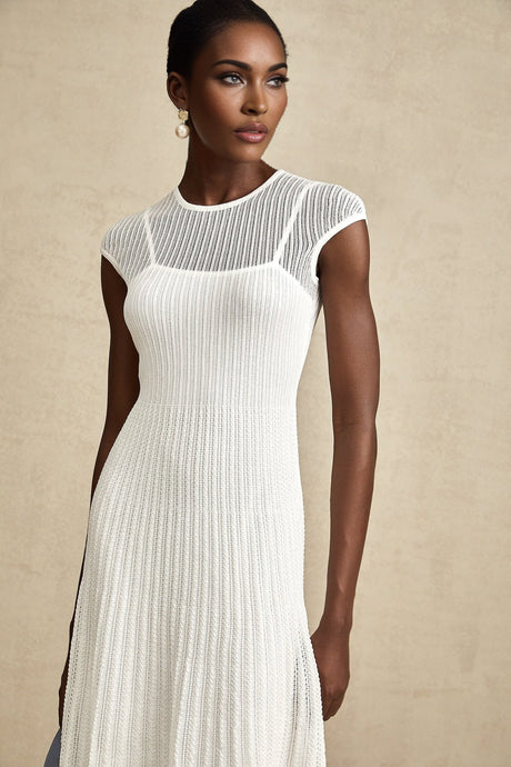 A white semisheer midi dress with scalloped hem and delicate details named Liane