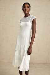 A white semisheer midi dress with scalloped hem details and delicate lace patterns named Liane