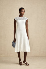 A white semisheer midi dress with scalloped hem details named Liane