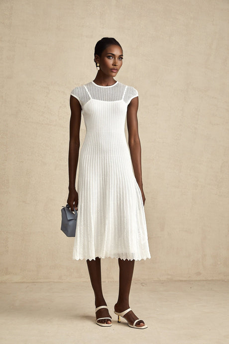 A white semisheer midi dress with scalloped hem details named Liane