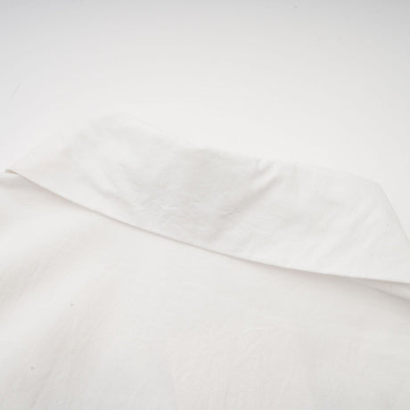 A white shirt with floral cutout patterns and a feminine design named Rosalie