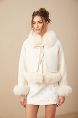 A white short coat made of suede with fur padding and a cozy appearance