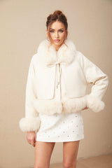 A white short coat made of suede with fur padding and a padded design featuring a cozy and stylish appearance suitable for cold weather