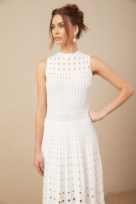 A white sleeveless midi dress with cutout details and a knitted fabric featuring a fitted silhouette and a high neckline