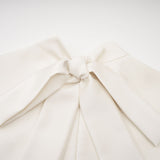 A white sleeveless midi dress with floral applique details named Emilie
