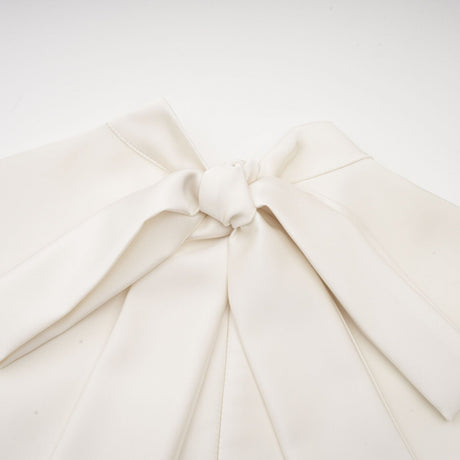 A white sleeveless midi dress with floral applique details named Emilie