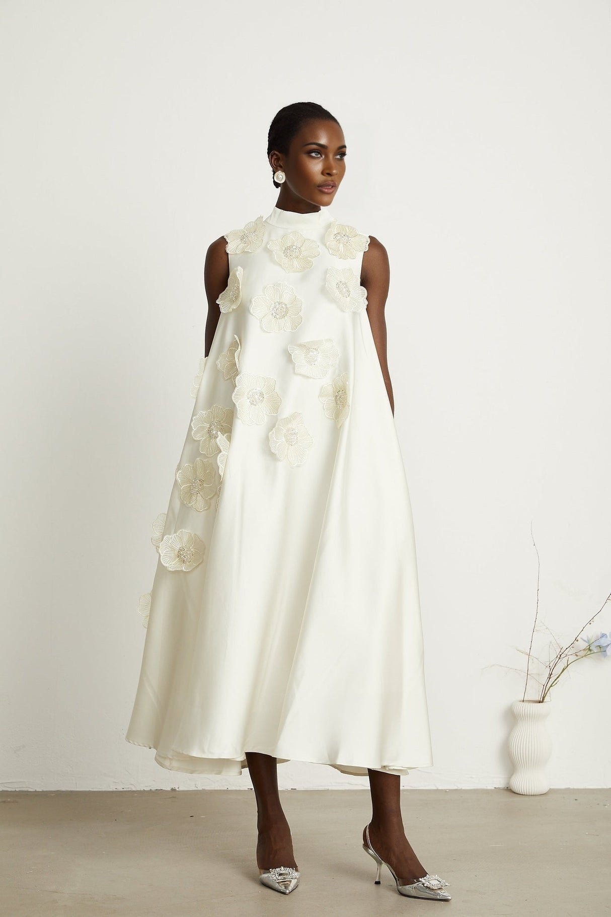 A white sleeveless midi dress with floral applique details named Emilie
