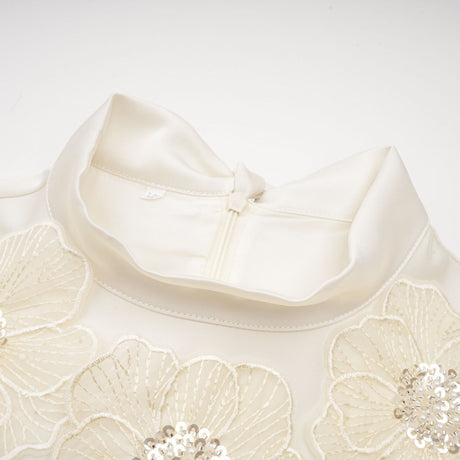 A white sleeveless midi dress with floral applique details named Emilie