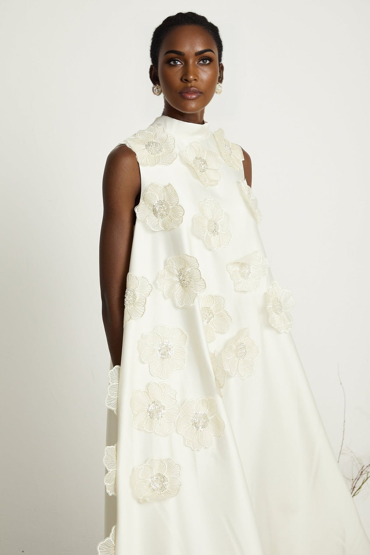 A white sleeveless midi dress with floral applique details named Emilie