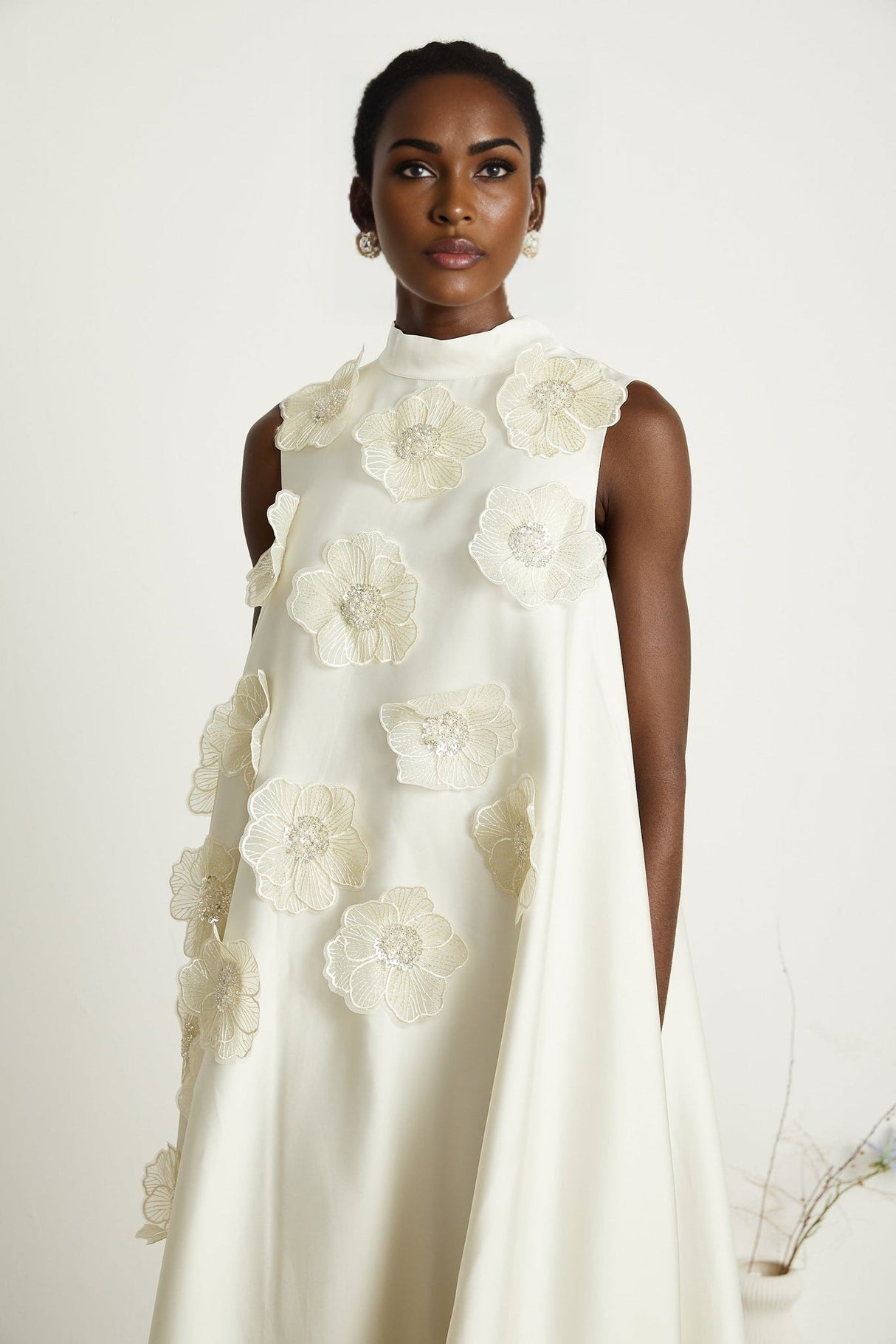 A white sleeveless midi dress with floral appliques called Emilie