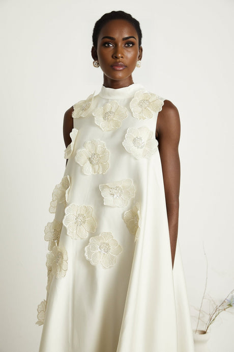 A white sleeveless midi dress with floral appliques called Emilie