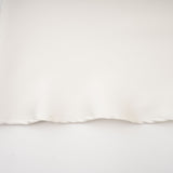 A white sleeveless midi dress with floral appliques called Emilie