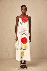 A white sleeveless midi dress with three dimensional petal details covering the bodice