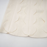 A white sleeveless mini dress with wavy details called Axelle