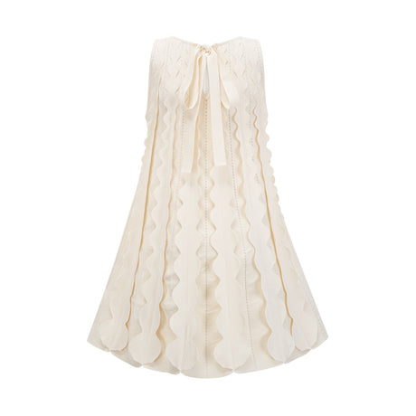 A white sleeveless mini dress with wavy details called Axelle