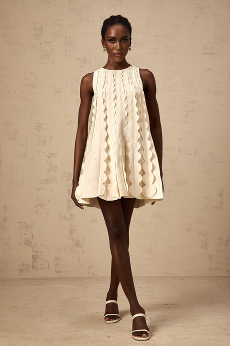 A white sleeveless mini dress with wavy details named Axelle