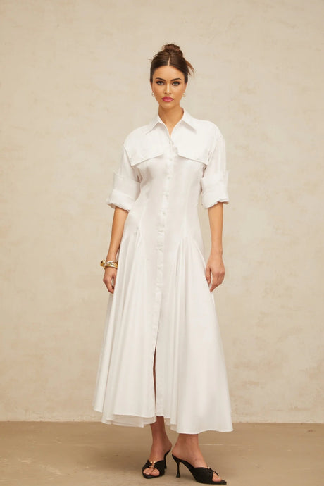 A white sleeveless shirt dress with a front slit and shirred waist detail