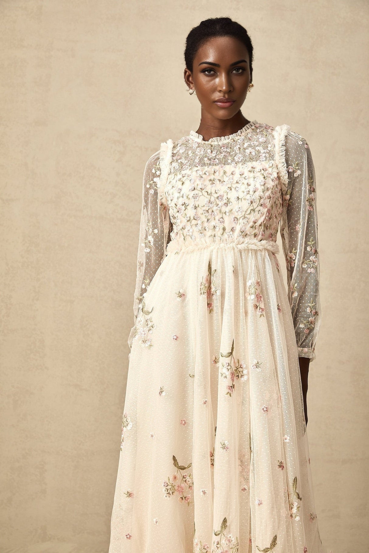 A white tulle midi dress with delicate floral embroidery featuring a Celine design with a fitted bodice and flowing skirt