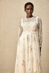 A white tulle midi dress with delicate floral embroidery featuring a Celine design with a fitted bodice and flowing skirt