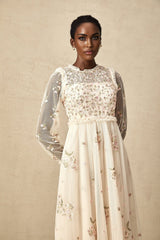 A white tulle midi dress with delicate floral embroidery featuring a Celine design with a sleeveless bodice and flowy skirt