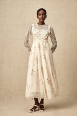A white tulle midi dress with delicate floral embroidery featuring a fitted bodice and flowing skirt by Celine