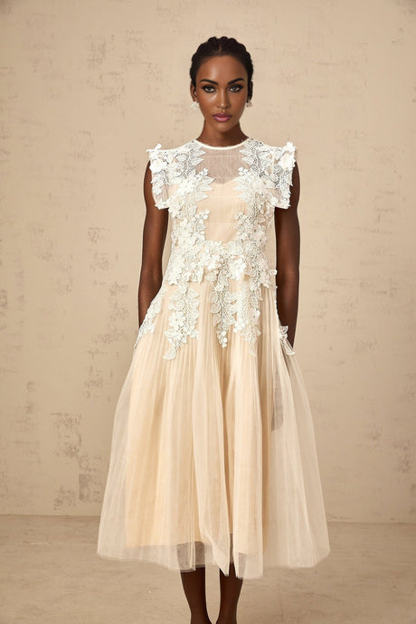 A white tulle midi dress with floral appliques scattered across the bodice and skirt featuring a fitted waist and delicate straps