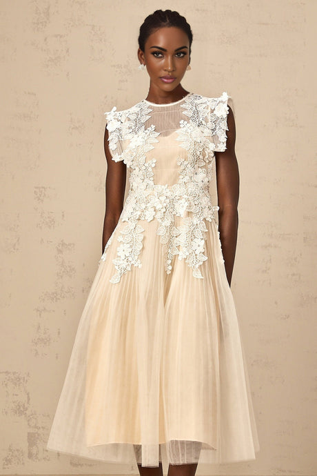 A white tulle midi dress with floral appliques scattered across the bodice and skirt featuring a fitted waist and delicate straps