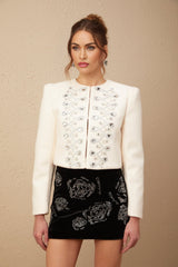 A white tweed jacket with crystal embellishments called Nerina featuring a classic design and sparkly accents