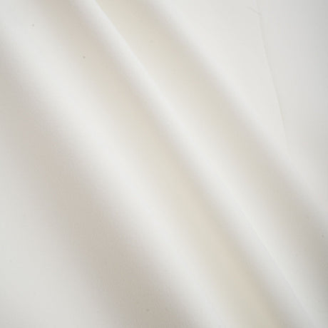 A white twopiece outfit consisting of a top and skirt adorned with crystal embellishments named Jeanne