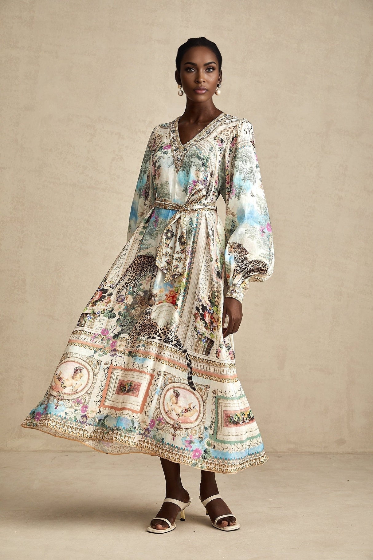 A woman wearing a belted midi dress with a V neckline in a casual yet elegant style
