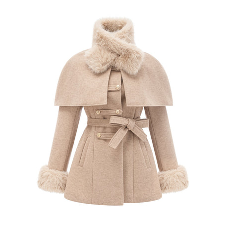A woman wearing a black coat with a detachable faux fur cape around the shoulders the cape extends to the elbows and has a luxurious fluffy texture
