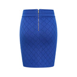 A woman wearing a blue knitted matching set consisting of a top with button details and a skirt
