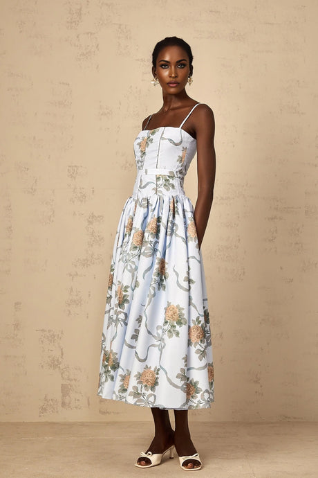 A woman wearing a blue midi dress with a floral print pattern
