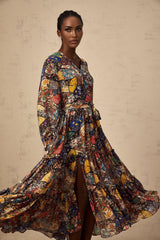 A woman wearing a brown bohemian style midi dress with shirring details and a flowy silhouette
