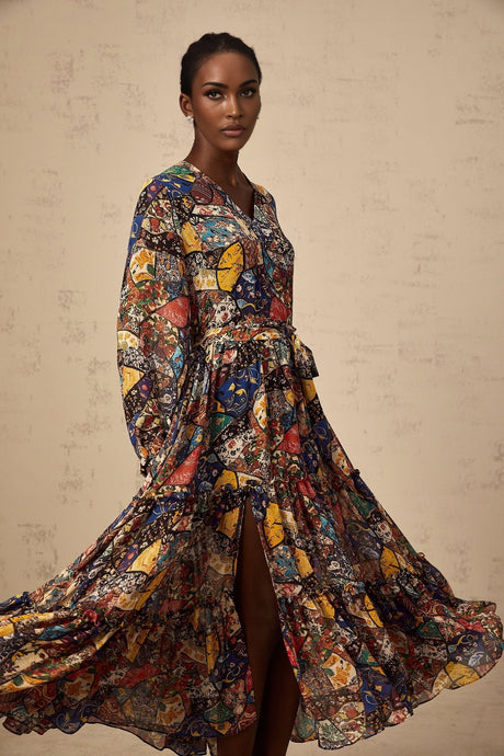 A woman wearing a brown bohemian style midi dress with shirring details and a flowy silhouette