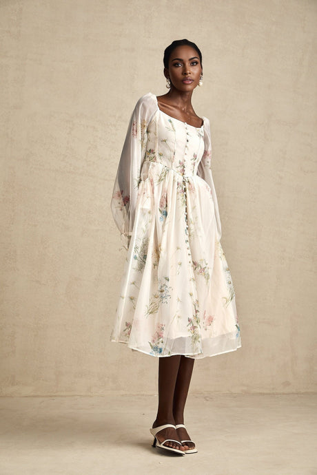 A woman wearing a floral print midi dress with a square neckline named Anne