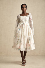 A woman wearing a floral print midi dress with a square neckline named Anne