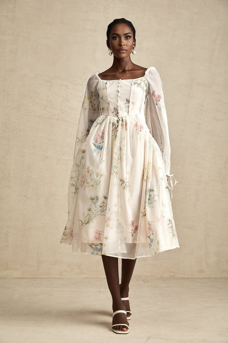 A woman wearing a floral print midi dress with a square neckline named Anne