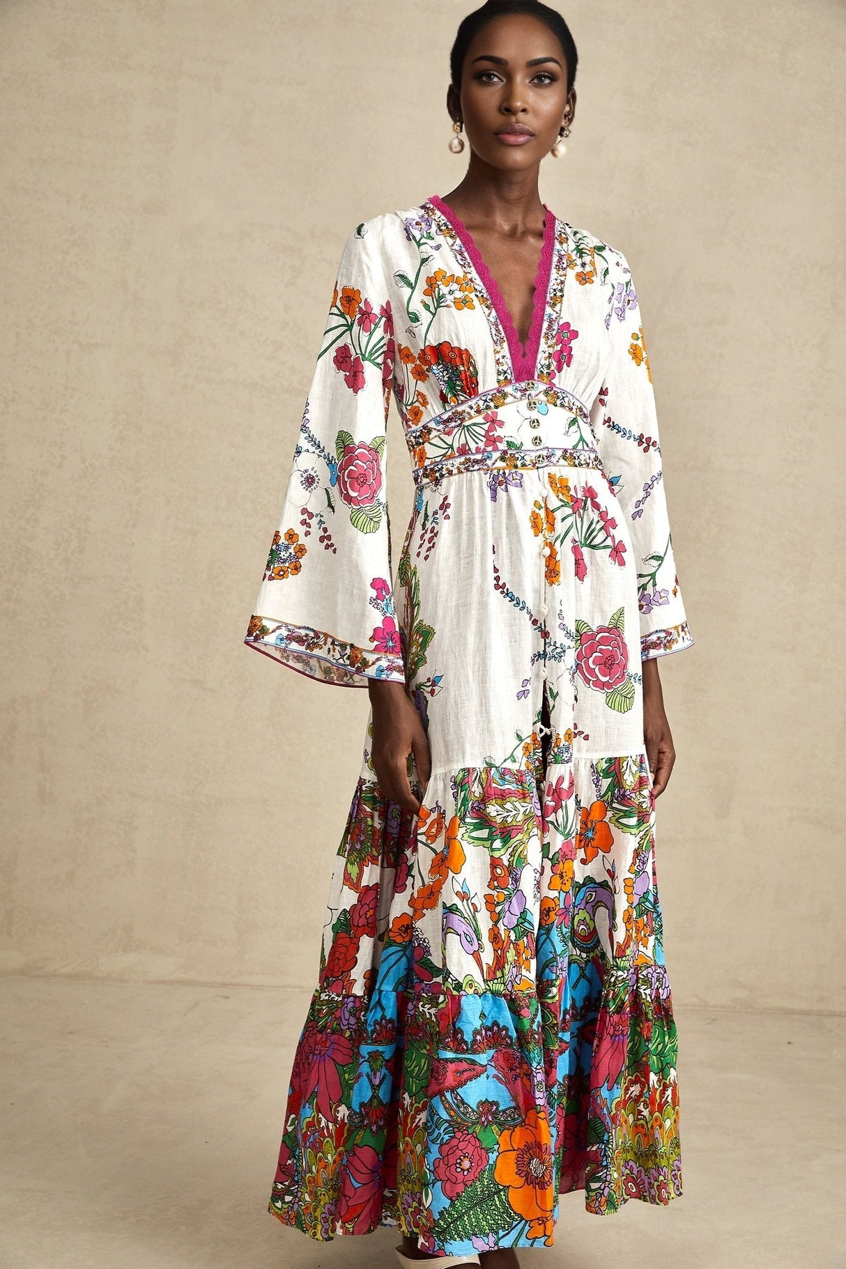 A woman wearing a floral print midi dress with a V neckline standing in a casual pose