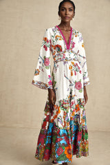 A woman wearing a floral print midi dress with a V neckline standing in a casual pose