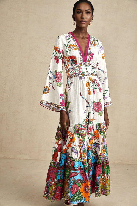 A woman wearing a floral print midi dress with a V neckline standing in a casual pose