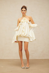 A woman wearing a floral print mini dress with cold shoulder design and ruffled details