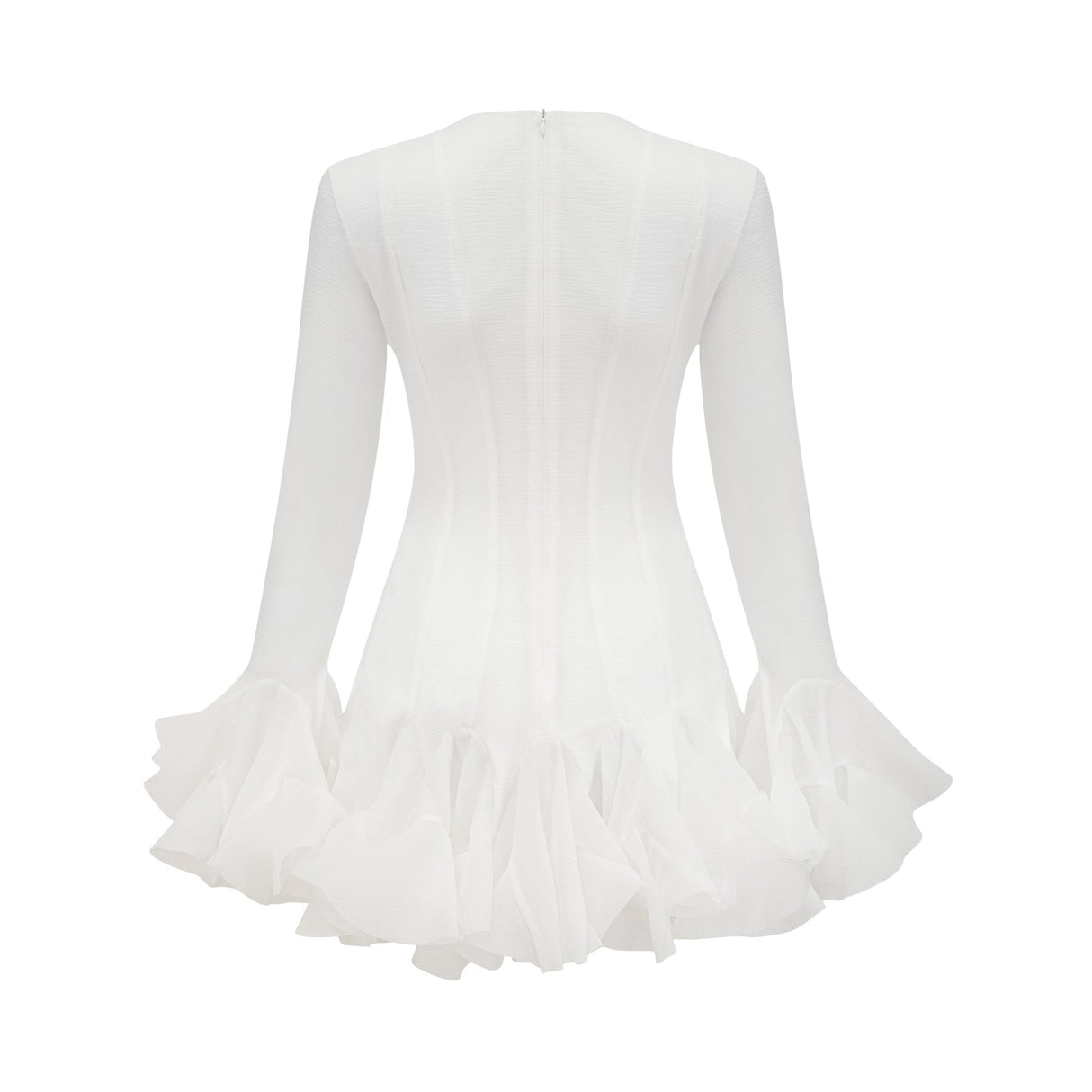 A woman wearing a flowy semi sheer white mini dress with flared sleeves and a loose fit standing against a plain background