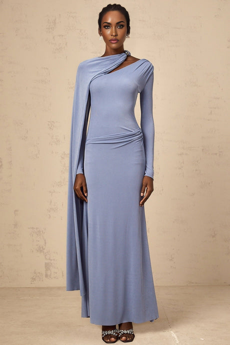 A woman wearing a long blue maxi dress with a diagonal shawl neckline and fitted silhouette