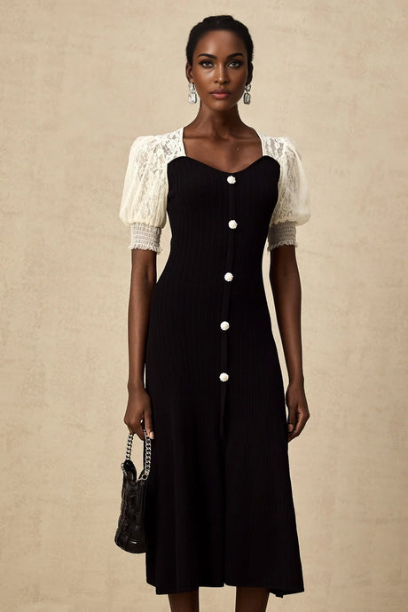 A woman wearing a long knit midi dress with lace trim details standing against a neutral background